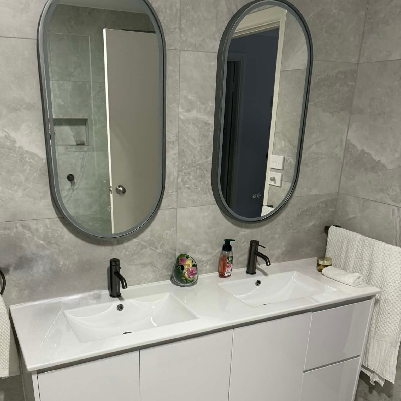 Double basin vanity with oval LED mirrors